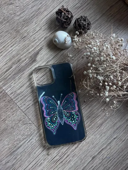A beautiful butterfly doodle on a black phone case insert.