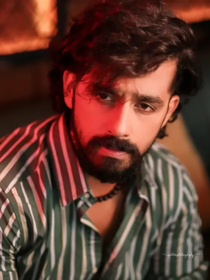 A collection of indoor portraits of an actor in a stylishly casual striped shirt. The moody lighting of the cafe setting adds a cinematic and modern feel, perfect for a character portfolio.