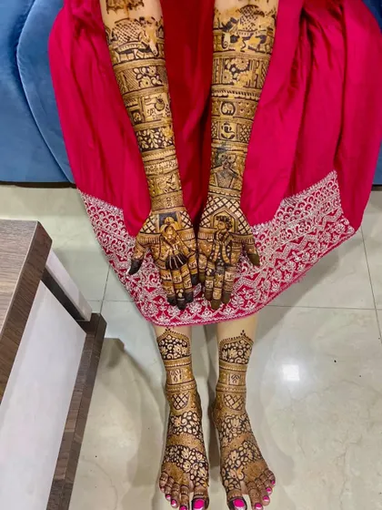 The complete bridal mehendi for Nidhi, with her hands and feet designs perfectly coordinated.
