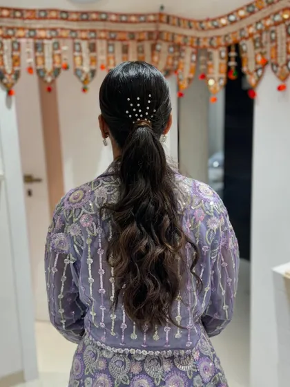 A back view of the simple yet elegant ponytail, a great choice for a long day of wedding festivities.