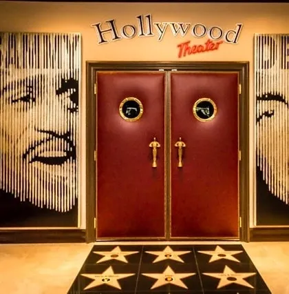 Make a grand entrance to your personal cinema. We create fully themed experiences, including custom doorways like this "Hollywood Theater" entrance, complete with classic marquee signage, Oscar-style handles, and a walk-of-fame floor design.