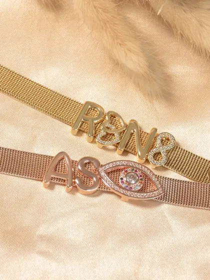 His and hers, best friends, or your own initials. These custom initial bracelets show how you can combine letters and charms like the evil eye for a meaningful piece.