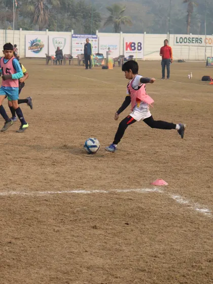 An action shot from the HCL league, showing a player mid-stride as he dribbles past a defender.