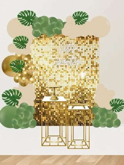 A mockup for a sophisticated party with a gold sequin wall, framed by olive green and beige balloons with monstera leaf accents.