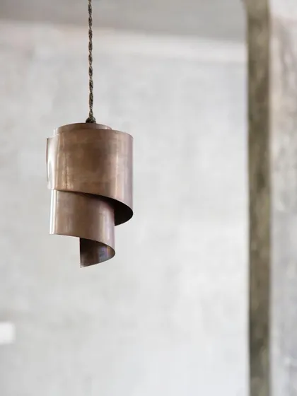 A custom-designed spiral copper pendant light, showcasing our attention to handcrafted details.