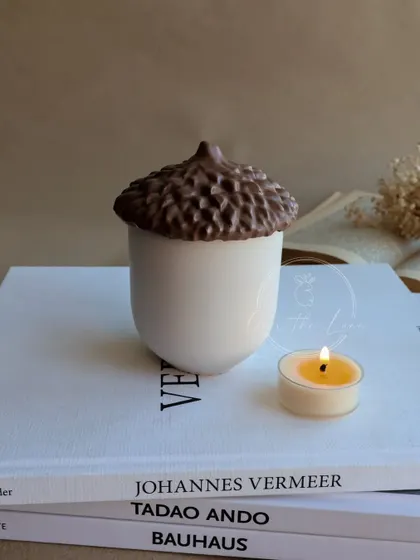 My new acorn-shaped eco-resin container. This whimsical jar is perfect for holding small treasures or for being used as a unique candle vessel.