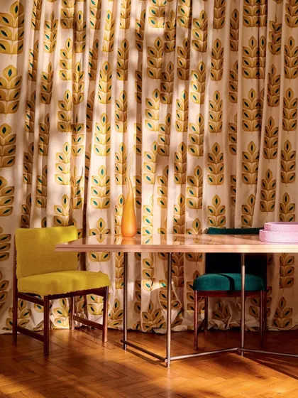 A dining room with curtains from the 'I'm Not Afraid' collection. The pop-inspired hues and energetic motifs channel a liberated, joyful spirit, turning the space into a celebration of self-expression.