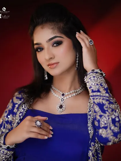 A bold and beautiful look with a royal blue outfit. The smokey eye and contoured cheeks create a high-impact, glamorous effect.