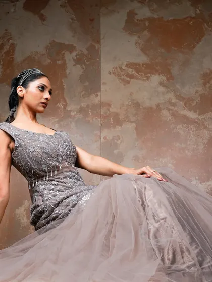 A seated pose that offers a different perspective on the gown. This shot highlights the detailed bodice and creates a feeling of relaxed glamour, perfect for an editorial story.