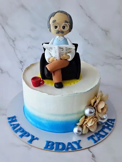 Morning dose of newspaper and coffee. A chocolate mousse cake for Thatha's birthday, featuring a figurine of him reading the paper.