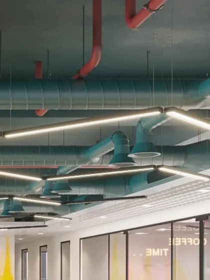 A view down a corridor showcasing the industrial-style ceiling design. The exposed mechanical, electrical, and plumbing systems are intentionally left visible as a key feature of the modern office aesthetic.