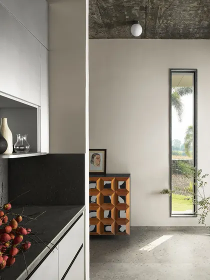 A detail of the kitchen and living area in Pavilion House, showing the clean lines and minimalist aesthetic.
