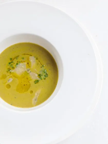 A beautifully presented cream-based soup, showing the importance of plating and garnishing.