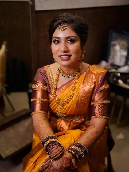 A close-up portrait showing the details of the makeup and the neatness of the hairstyle.