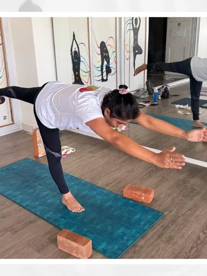 A student holds Virabhadrasana III (Warrior III), a pose that requires immense focus and control, embodying the art of balance we teach.