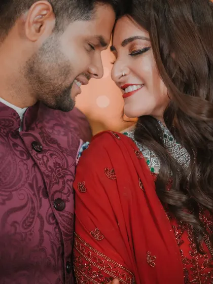 A close-up of the couple, their noses touching, sharing a sweet and intimate smile. A perfect capture of their love and connection.