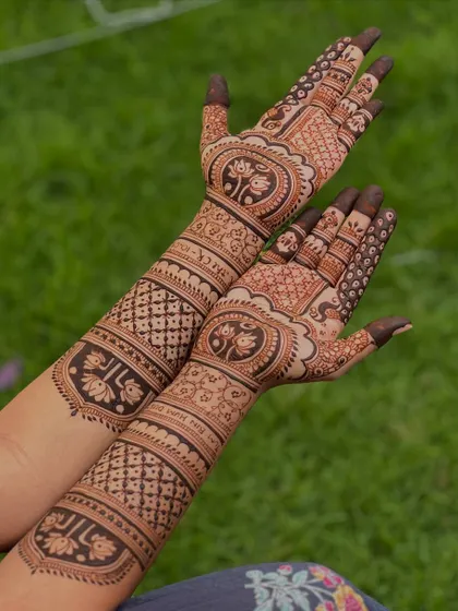 An angled shot of a personalized bridal mehendi, giving a clear view of the intricate work on the arms.