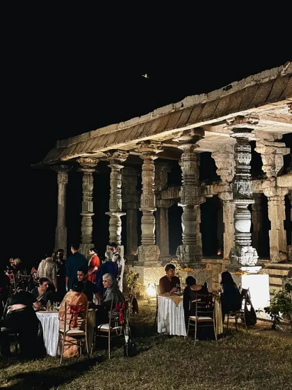 A stunning nighttime event set against the ancient pillars of Hampi. The dramatic lighting and historical backdrop created a truly unique dining experience.