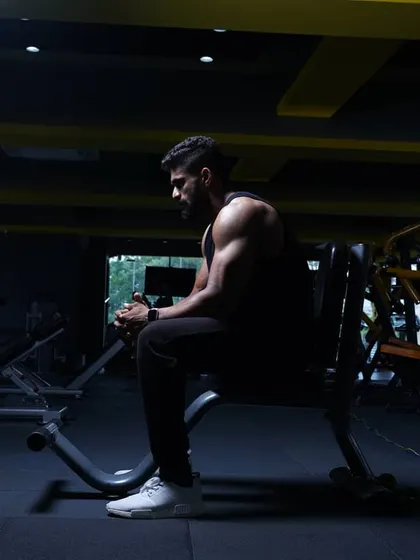 Even in the shadows, the work shows. This is a candid shot between workouts, a reminder that the process is a constant state of being under construction.