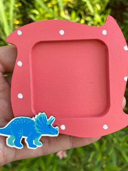 A fun dinosaur-themed photo magnet, perfect for a kid's room or for any dino lover.