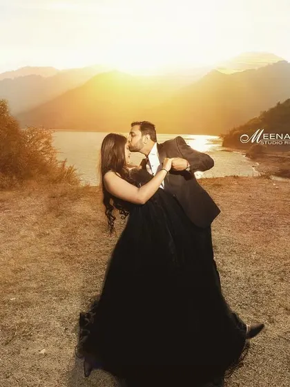 A romantic sunset portrait from a pre-wedding shoot in Tehri. The golden light and the mountain lake backdrop create a truly magical and memorable scene.