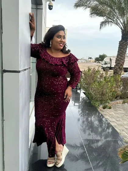 Posing outdoors in a sparkling magenta gown. The color and fit of this dress were perfect for an evening event.