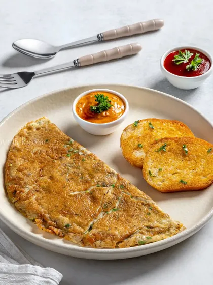 A classic masala omelette served with two dips and toasted bread.