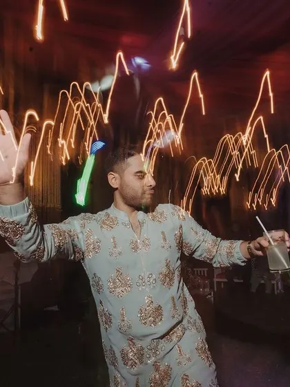 A guest caught in a moment of pure dancing joy, with light trails creating a sense of motion and energy.