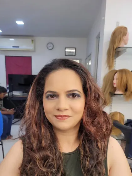 A full-face view of the cool-toned grey and blue smokey eye. The soft waves in the hair complete this elegant evening look.