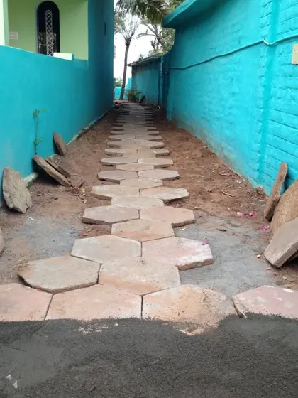 The beginning stages of laying an irregular-shaped stone pathway. Each stone is chosen to fit together like a puzzle.