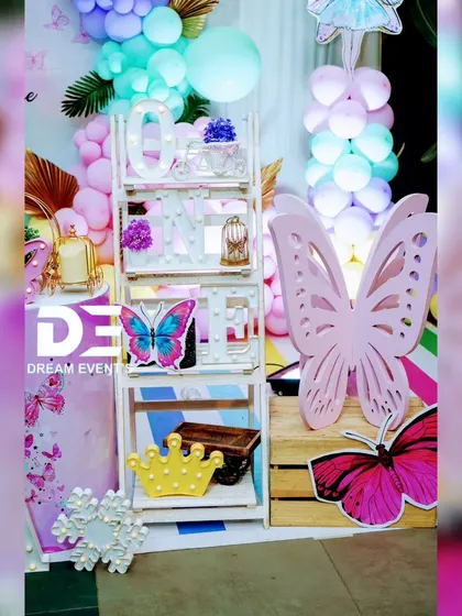 More prop details from a butterfly-themed birthday, including a light-up 'ONE' shelf and a large, decorative butterfly cutout.