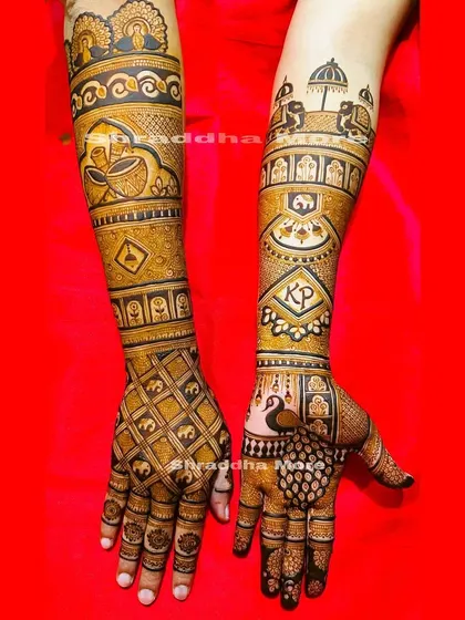 This bridal design is packed with traditional symbols. It features a baraat scene with elephants and an umbrella, a diya, and the couple's initials 'KP' for a personal touch.