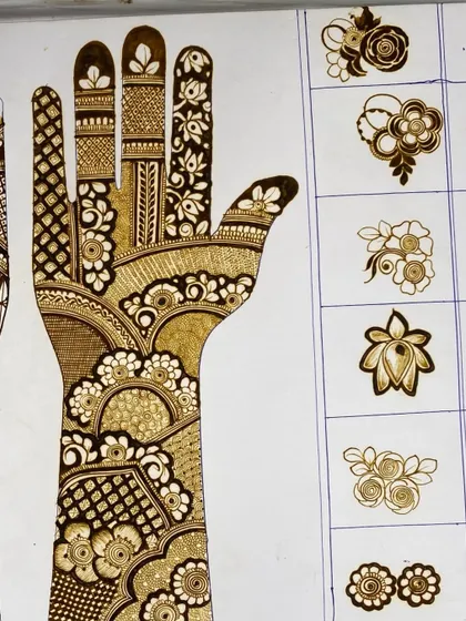 Here you can see how we practice creating different floral elements. From simple buds to full blooms and lotuses, flowers are a core part of my mehandi design training.