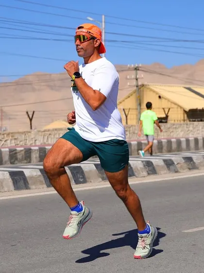I'm captured in full flight during the Ladakh Marathon. Running at this altitude requires specific conditioning and mental toughness, which I train my clients for.