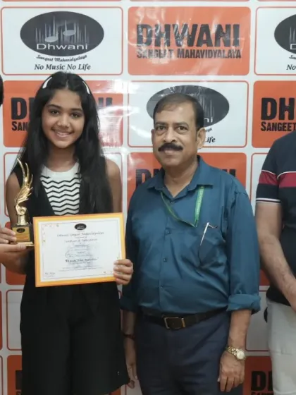 A young lady receives her award from our faculty members. We encourage students of all ages to pursue their passion and celebrate their success.