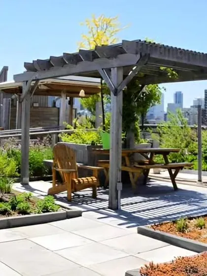 A rooftop terrace garden with a wooden pergola and built-in planters. This design transforms an unused roof into a beautiful and functional green space.