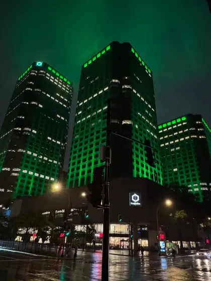 The stunning green-lit buildings of downtown Montréal on a rainy night.