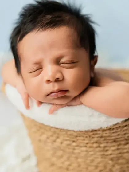 A basket full of love. This pose, with the baby's chin resting on their hands, is a favorite for showing off their adorable, chubby cheeks.