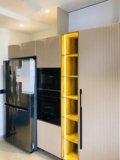 We designed this tall unit to house the refrigerator and built in appliances, with a brightly lit open shelf for easy access to everyday items.