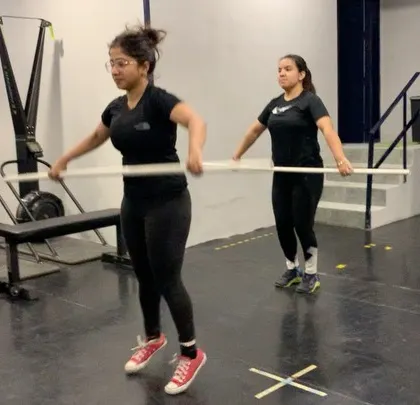Beginners learning the basics of the clean and jerk with PVC pipes during a seminar. These events are open to everyone and are a great way to focus on technique in a supportive environment.