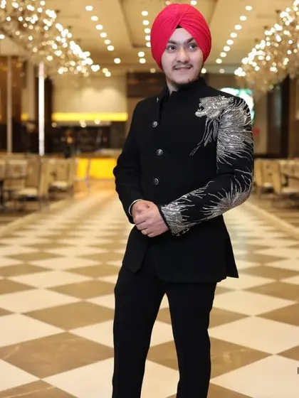 A full-length view of the custom dragon-embroidered bandhgala. The asymmetrical design adds a modern edge to the traditional silhouette, perfect for making an entrance.