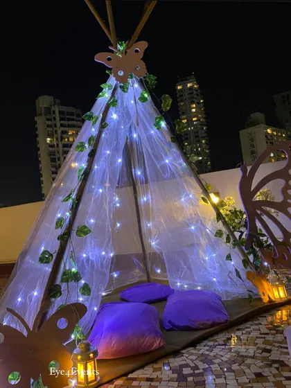 Another view of the butterfly themed teepee tent against the night sky. This cozy little nook, filled with soft purple cushions, provided a magical photo corner and hangout spot for the birthday celebration.