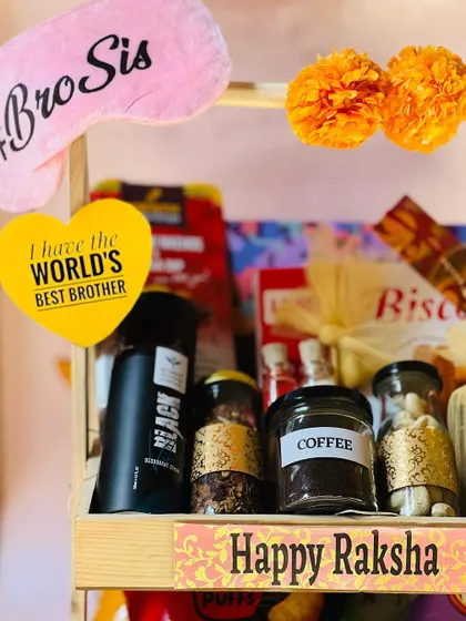 A detailed shot of the top tier of the brother's Rakhi hamper, showing jars of coffee and other gourmet items.
