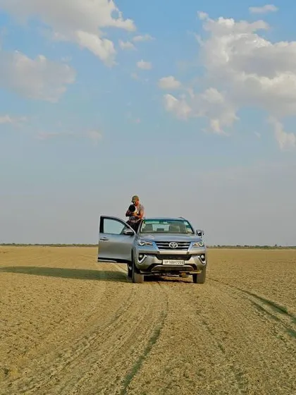 A drone's eye view of me and my vehicle in the vast, empty expanse of the Sambhar Salt Lake. This shows the scale of the landscapes we explore on these specialized tours.