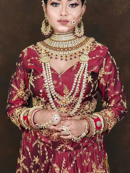 This is a very grand, layered bridal set with a choker and multiple long necklaces. The design is perfect for creating a statement look for your wedding day.