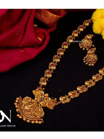 A beautiful long temple necklace with a Lakshmi pendant. This piece can be layered or worn on its own for an elegant look.