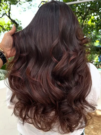 The back view of the 'Chocolate Mahogany Brown' color, styled with soft waves.