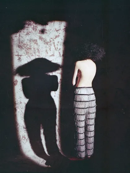 An artistic shot from an archival film project, playing with light and shadow. The silhouette creates a mysterious and compelling narrative, focusing on form over detail.