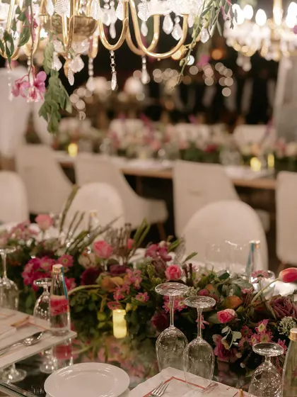 The art of celebration is in the details. This shot from a finale dinner shows our meticulous approach to tablescaping, where fresh floral arrangements, elegant glassware, and ambient lighting come together to create an unforgettable dining experience.