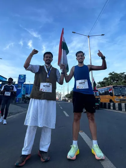Two runners, one in traditional wear, celebrate their achievement together at the Freedom Run.